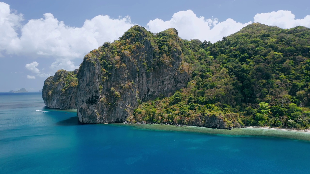 拉根岛的石灰岩。El Nido，巴拉望岛，菲律宾。天堂般的热带沙滩Ipil海滩，蔚蓝的海水，椰子树和当地的船停泊。视频素材