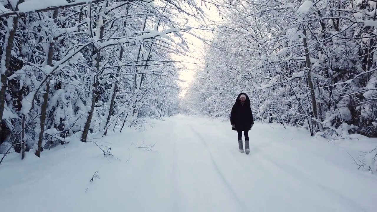 一个女人走在雪林里视频素材