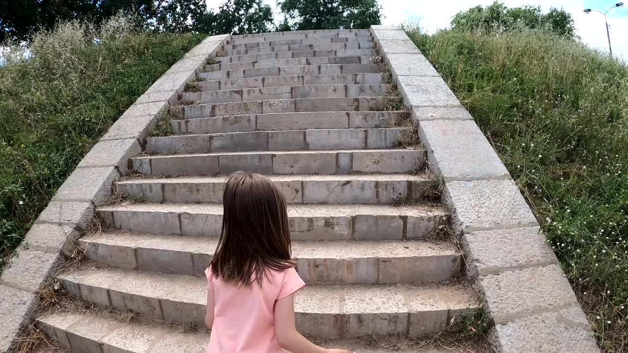 一个小女孩正在河边的公园里玩耍视频下载