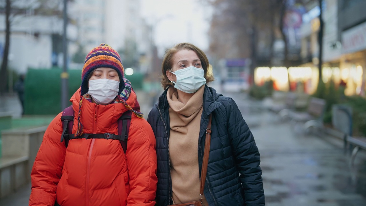 年轻的女游客和当地的人在城市的冬季散步和观光视频素材