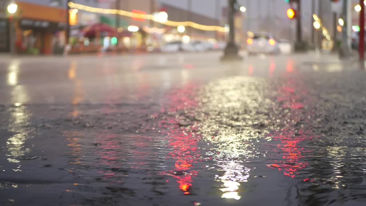 灯光反射，雨天道路。雨点，潮湿的城市街道沥青视频素材