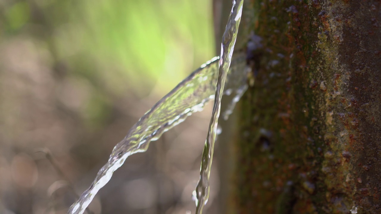 泉水里的清水从铁管里流出来视频素材