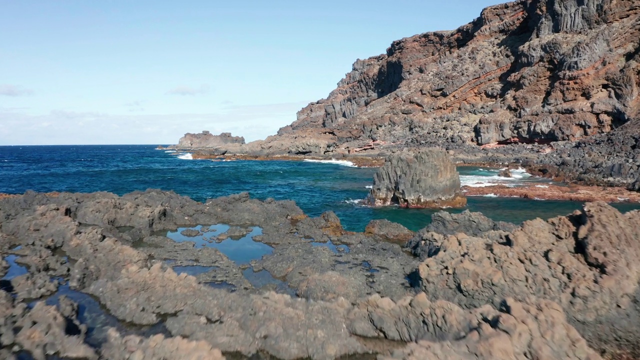 空中摄影车在阳光明媚的大西洋海岸与火山浮雕视频素材