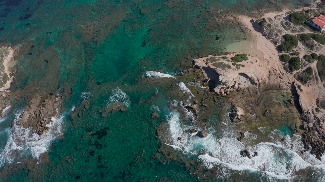 正上方无人机拍摄:热带海滩，海浪拍打岩石海岸的俯视图。视频素材