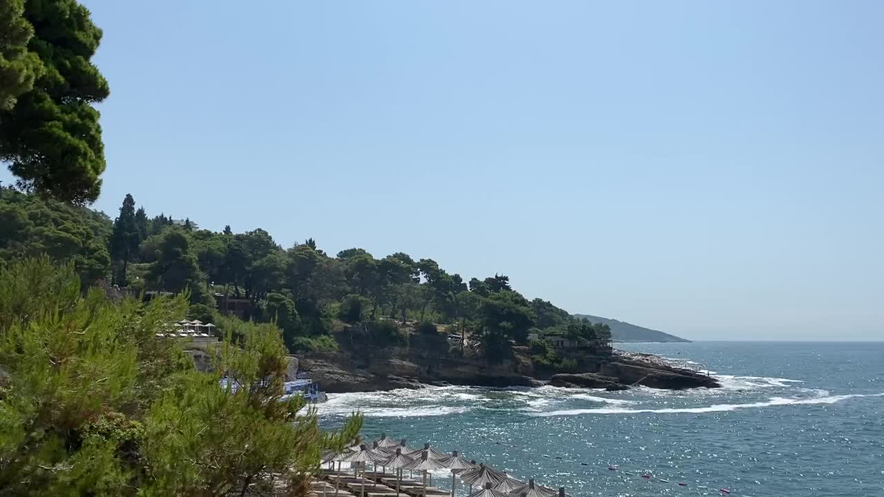 夏天的海滩海景。世外桃源般的海滩坐落在岩石嶙峋的地中海沿岸，四周是常绿的松树。放松的假期，在地中海度假。神奇的夏天海景。视频素材