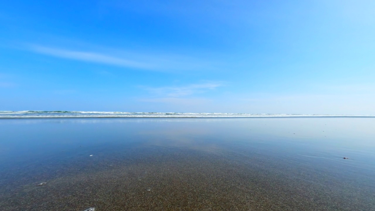 飞溅的波浪在海滩上。海浪拍打着相机视频素材