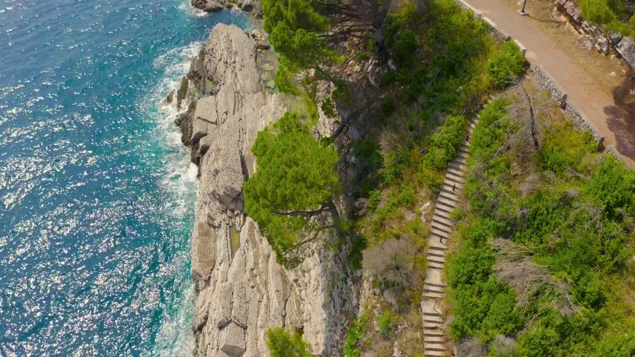 鸟瞰图，蓝绿色的海与岩石海岸和台阶在Petrovac，黑山。视频素材