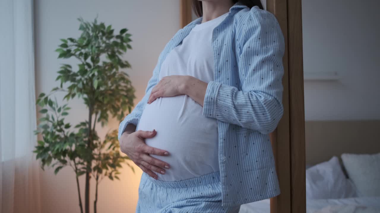 孕妇在家抚摸自己的肚子视频素材