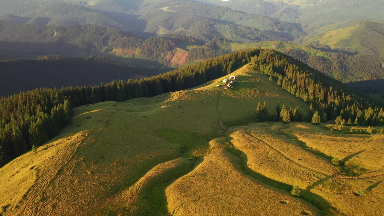 在阳光明媚的一天，航拍的绿色高山牧场。视频素材