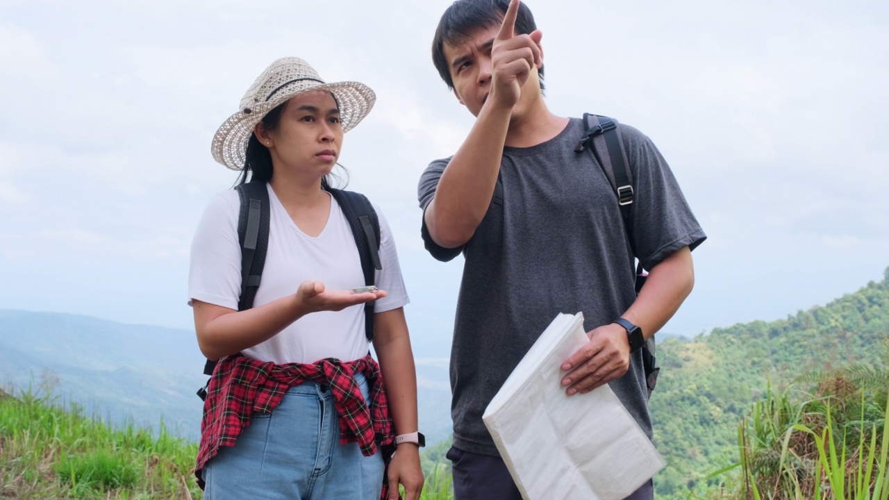 女背包客站在山顶，高举双臂，欣赏风景。旅程与成功理念视频素材