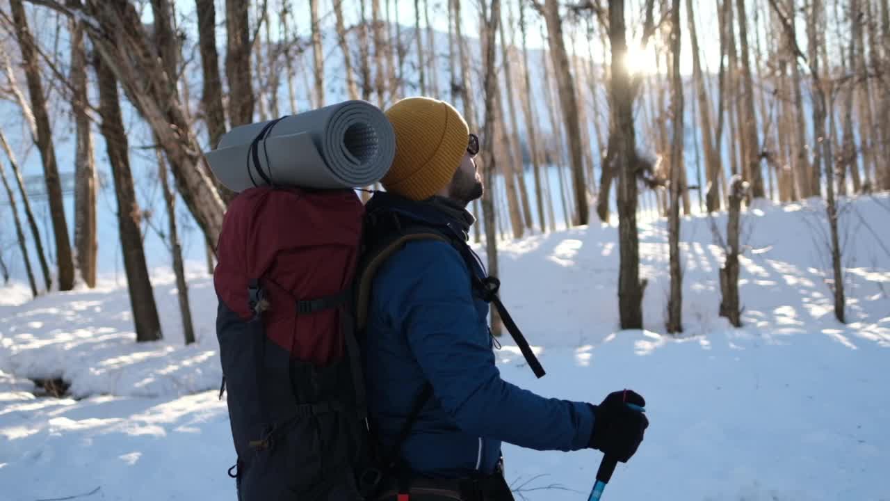 冬天背着背包在山里徒步旅行的人视频素材