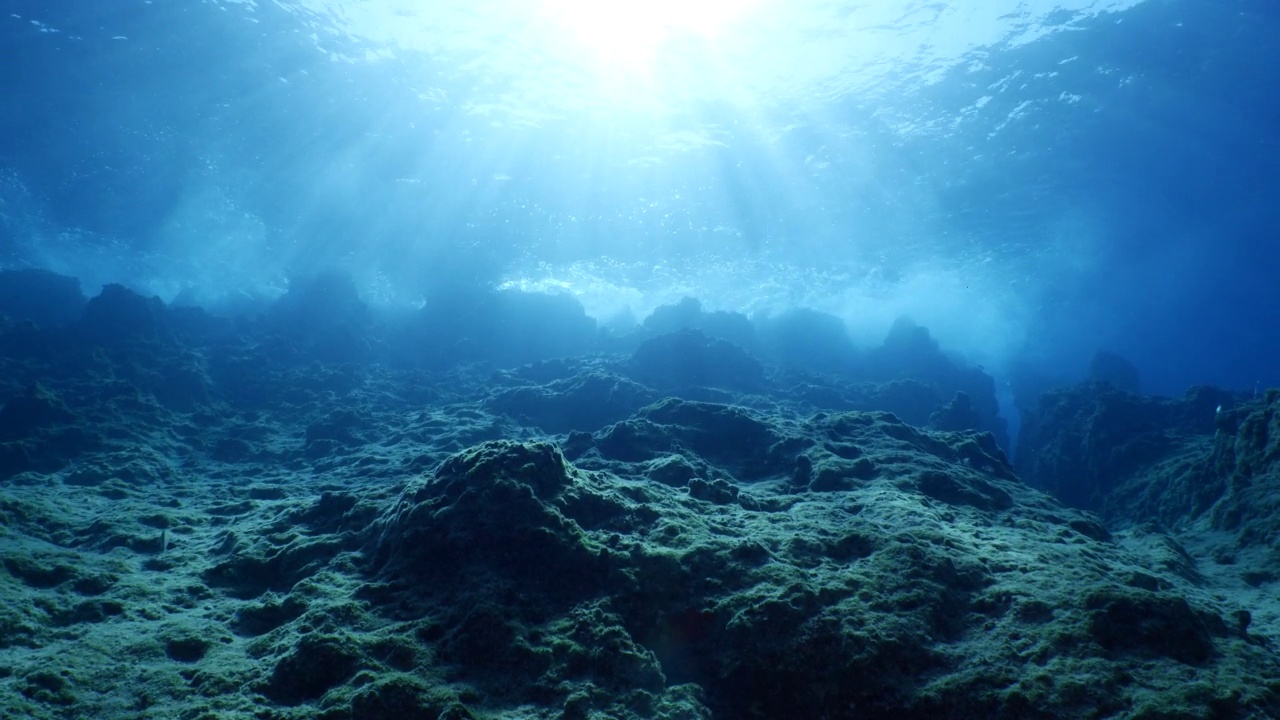 波涛汹涌的海水，波涛汹涌的海水，水下的海浪撞击着岩石，在海面上形成泡沫，形成海洋风景的背景视频素材