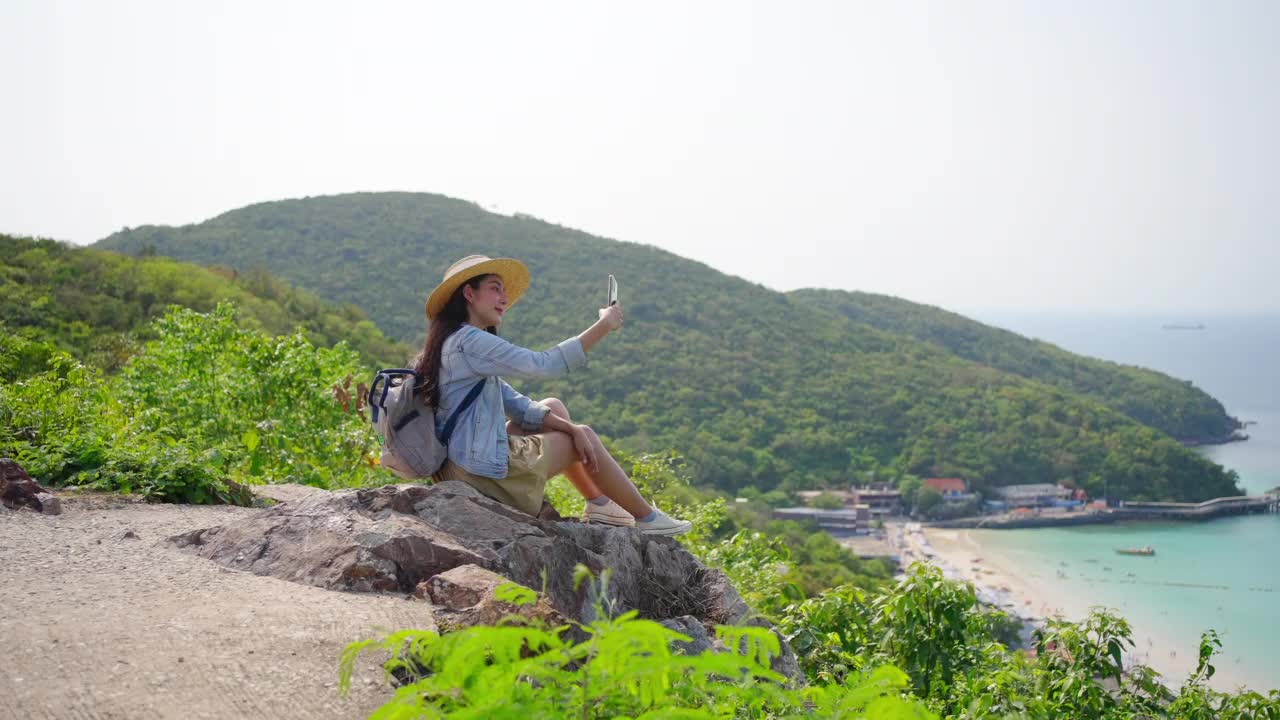 年轻的亚洲女性在热带岛屿度假旅行时用手机自拍视频素材