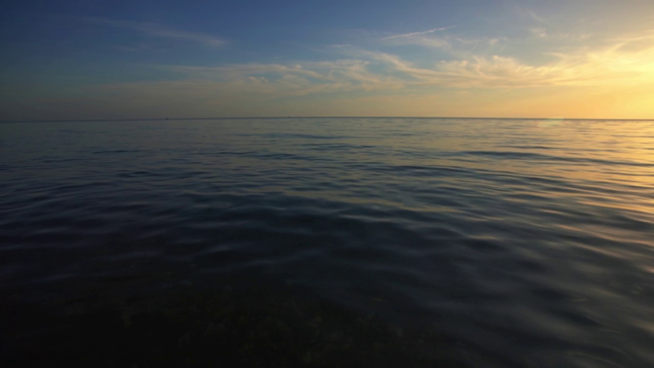 日落在平静的海面上，抽象的自然背景视频素材