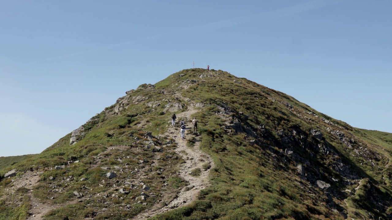 背包旅行者爬上山顶。爬到山顶。山的风景。喀尔巴阡山。视频素材