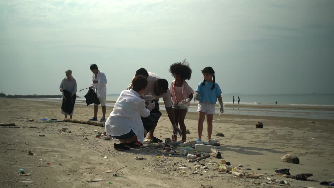 志愿者活动，家庭帮助在海滩上捡垃圾视频下载