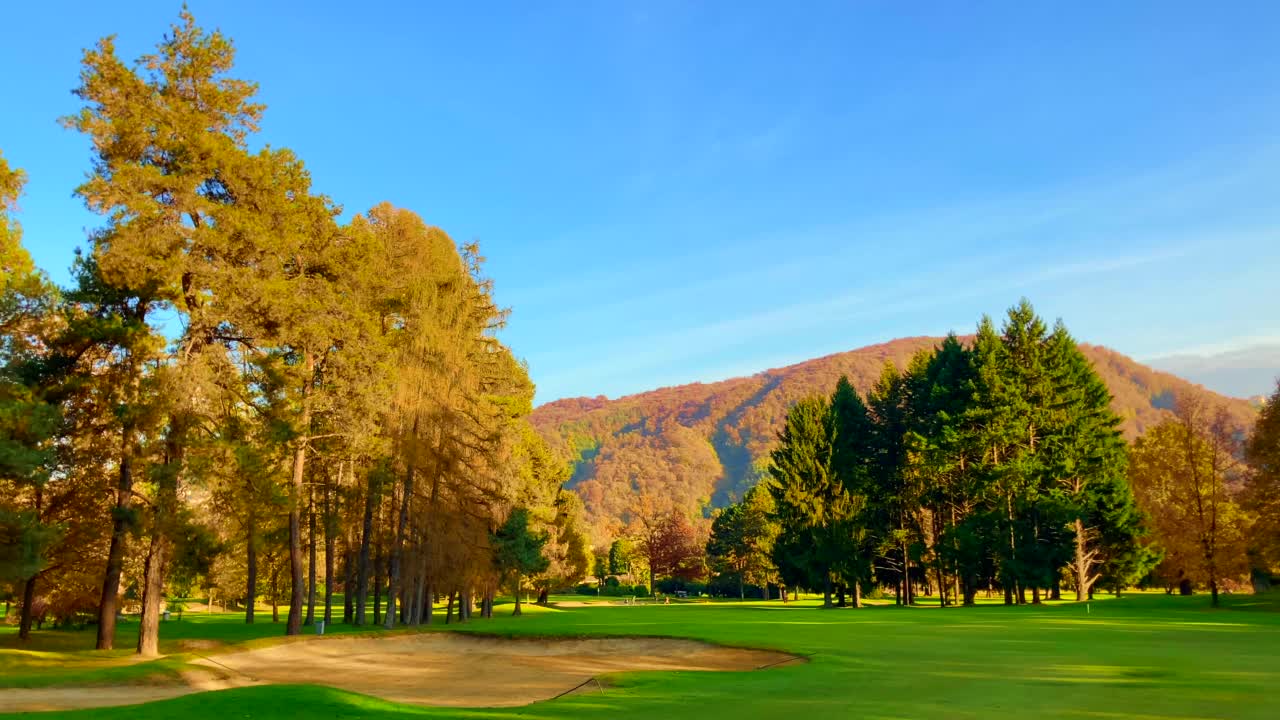 高尔夫球场5洞秋天与山景和沙坑在晴朗的一天视频素材