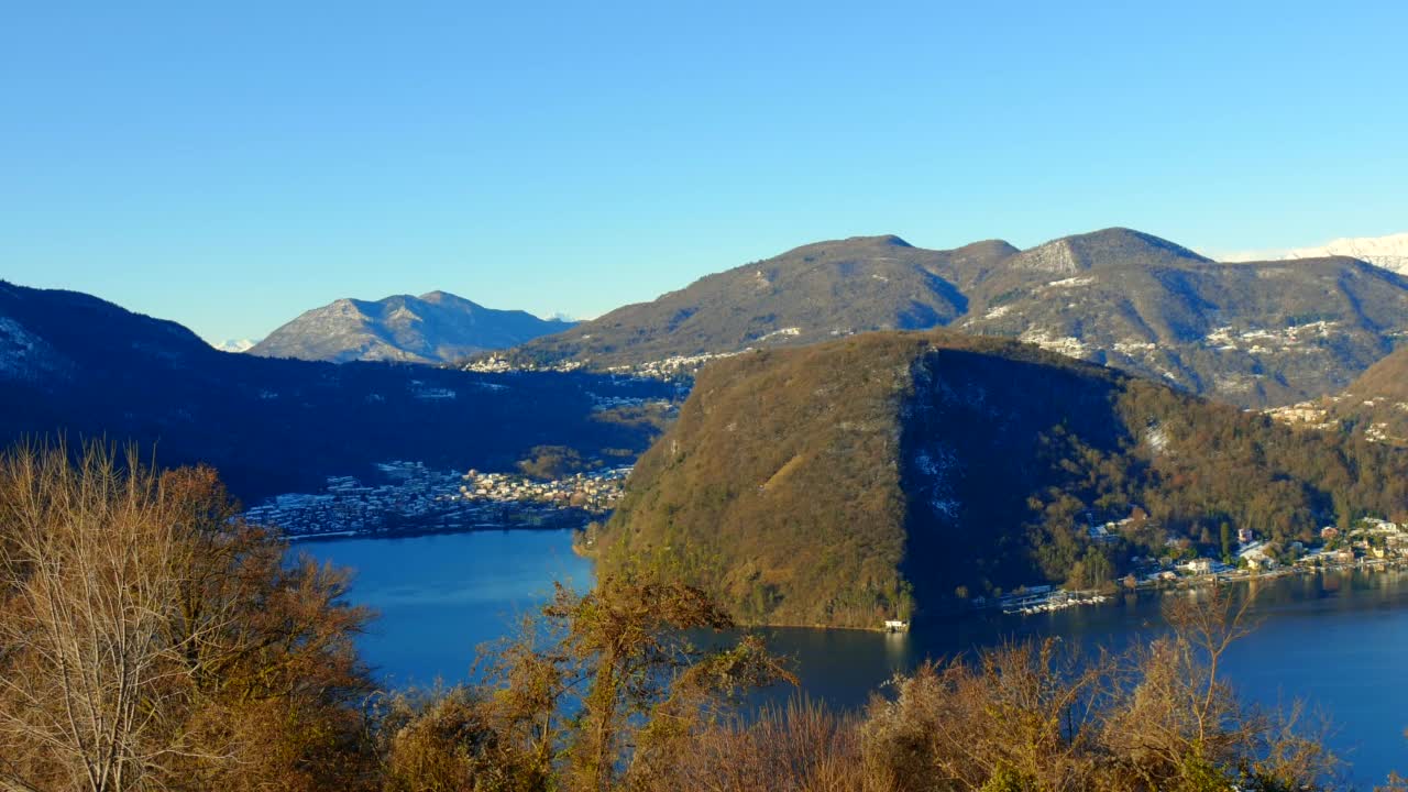 拉维纳城在蓬特特蕾莎与卢加诺湖和山景与雪和晴朗的蓝天在晴朗的一天视频素材