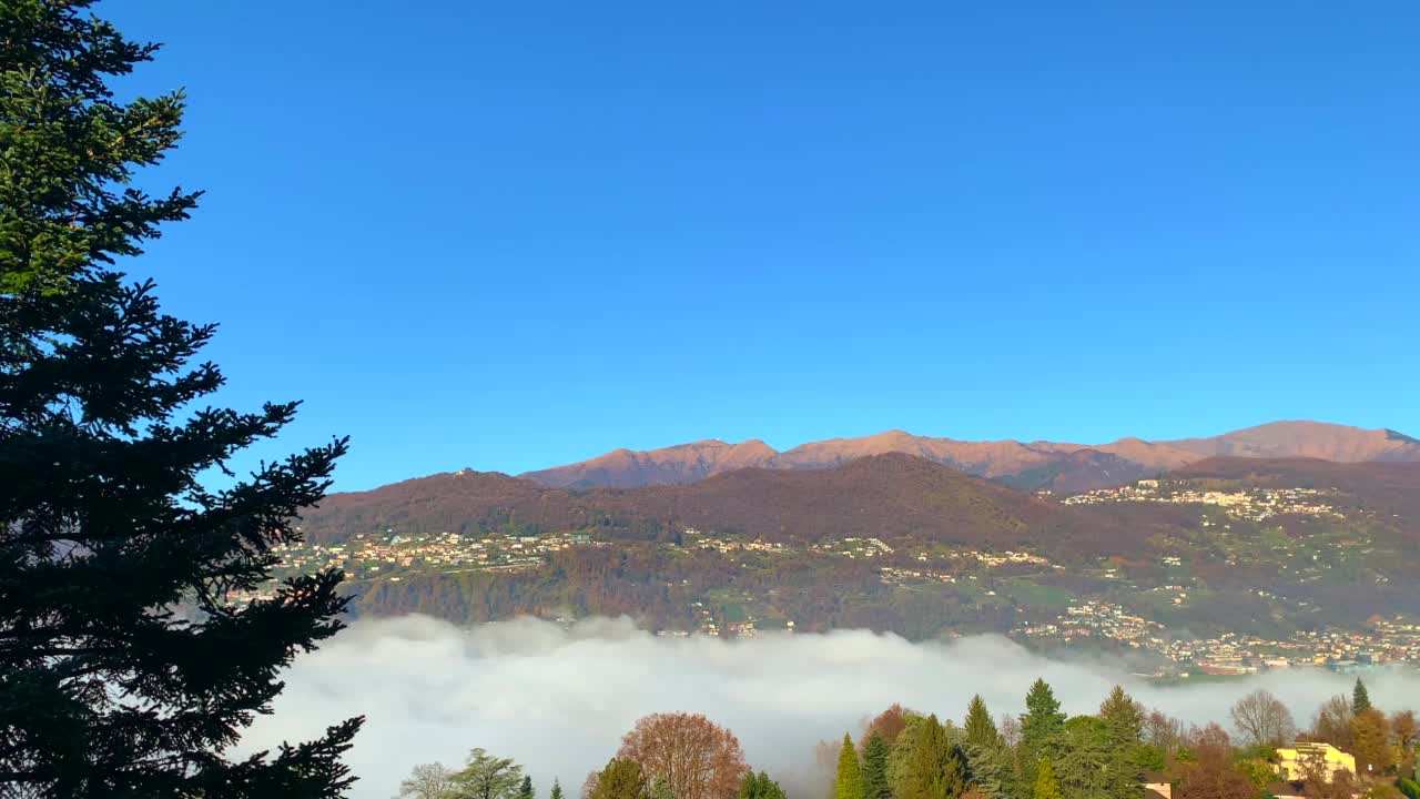 高山湖卢加诺的全景与云海和山在一个晴朗的秋日视频素材