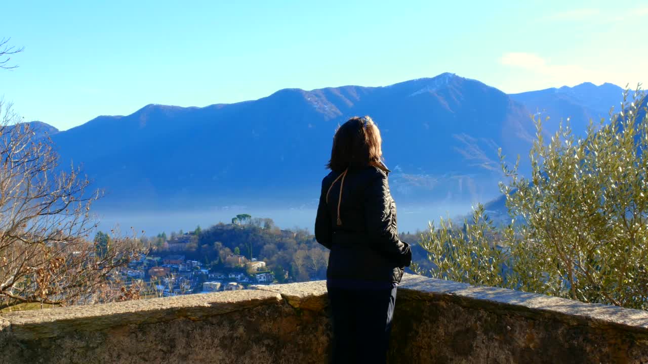 阳光明媚的日子里卢加诺湖的山景和卢加诺的城市风景视频素材