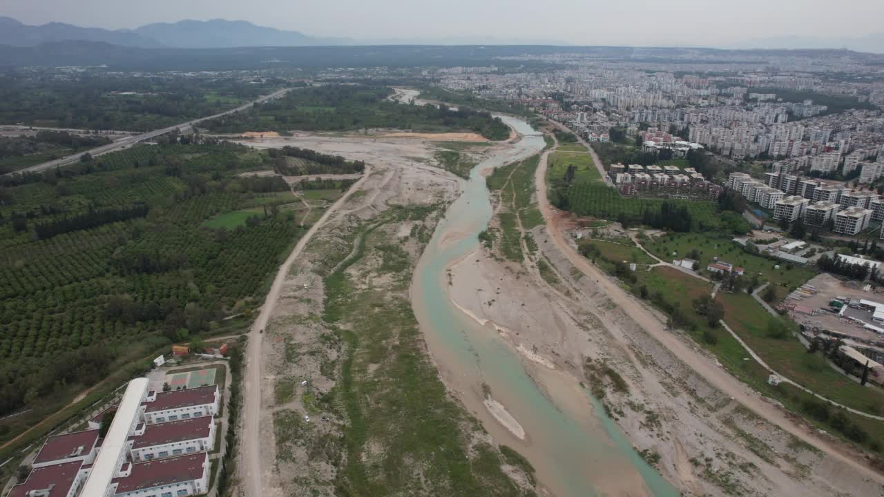 用无人机在市中心的河床上空飞行。视频素材