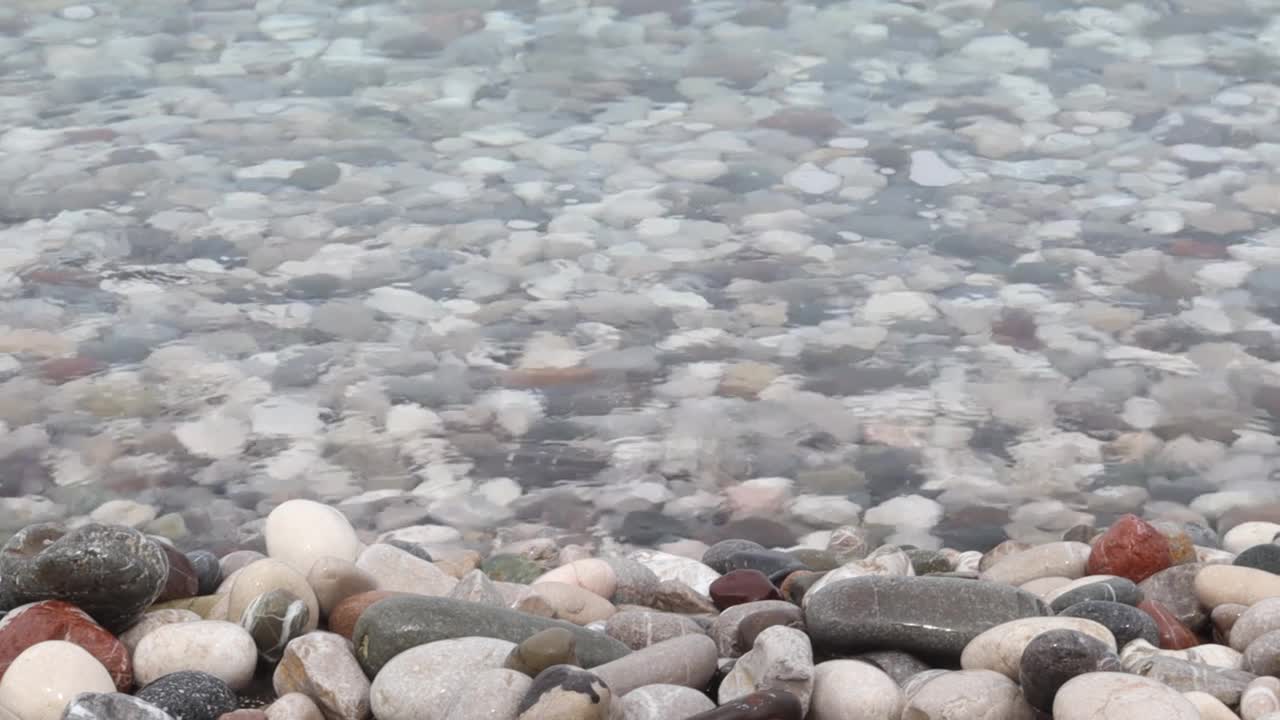 海浪倾泻在卵石滩上视频素材