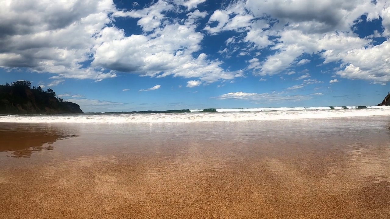 海浪在巨大的沙滩上奔腾视频素材