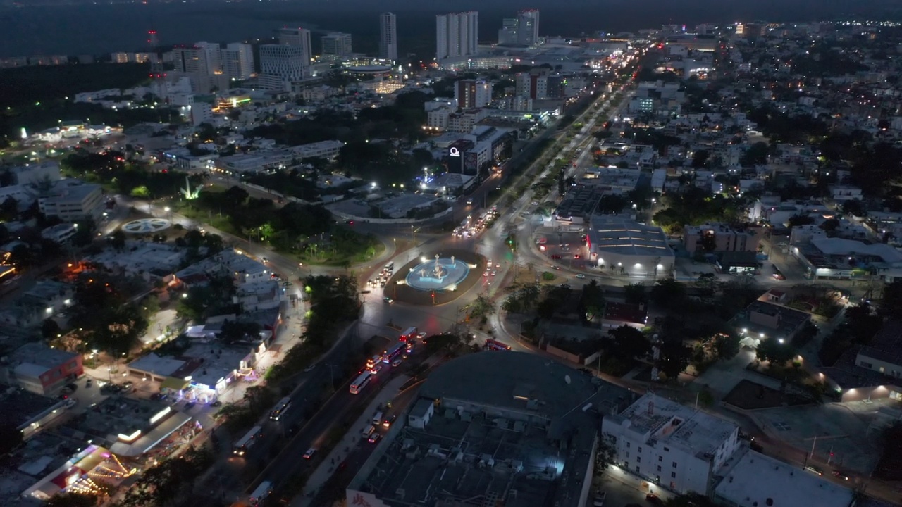 夜间城市繁忙道路拦截的鸟瞰图。在环形交叉路口的Ceviche gloria del Ceviche地标下倾斜。墨西哥坎昆视频素材