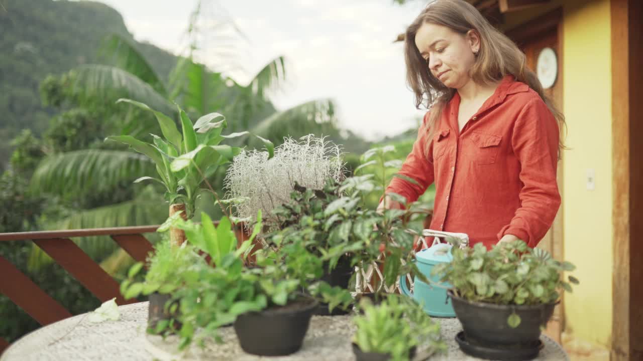 一名妇女正在院子里用剪刀修剪盆栽视频素材