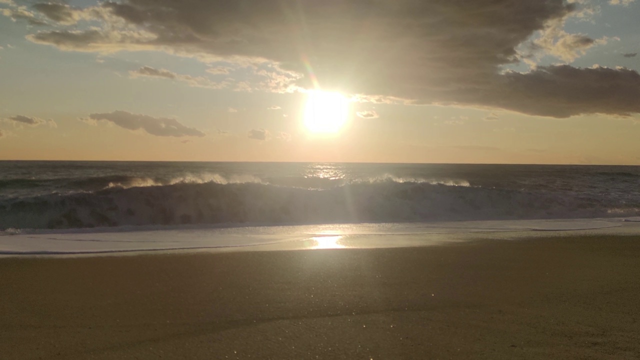 日落在海水上的景色。黄昏时金色的太阳在五彩的天空，海浪冲向海滩。幻想日落在无缝循环的海洋。视频素材