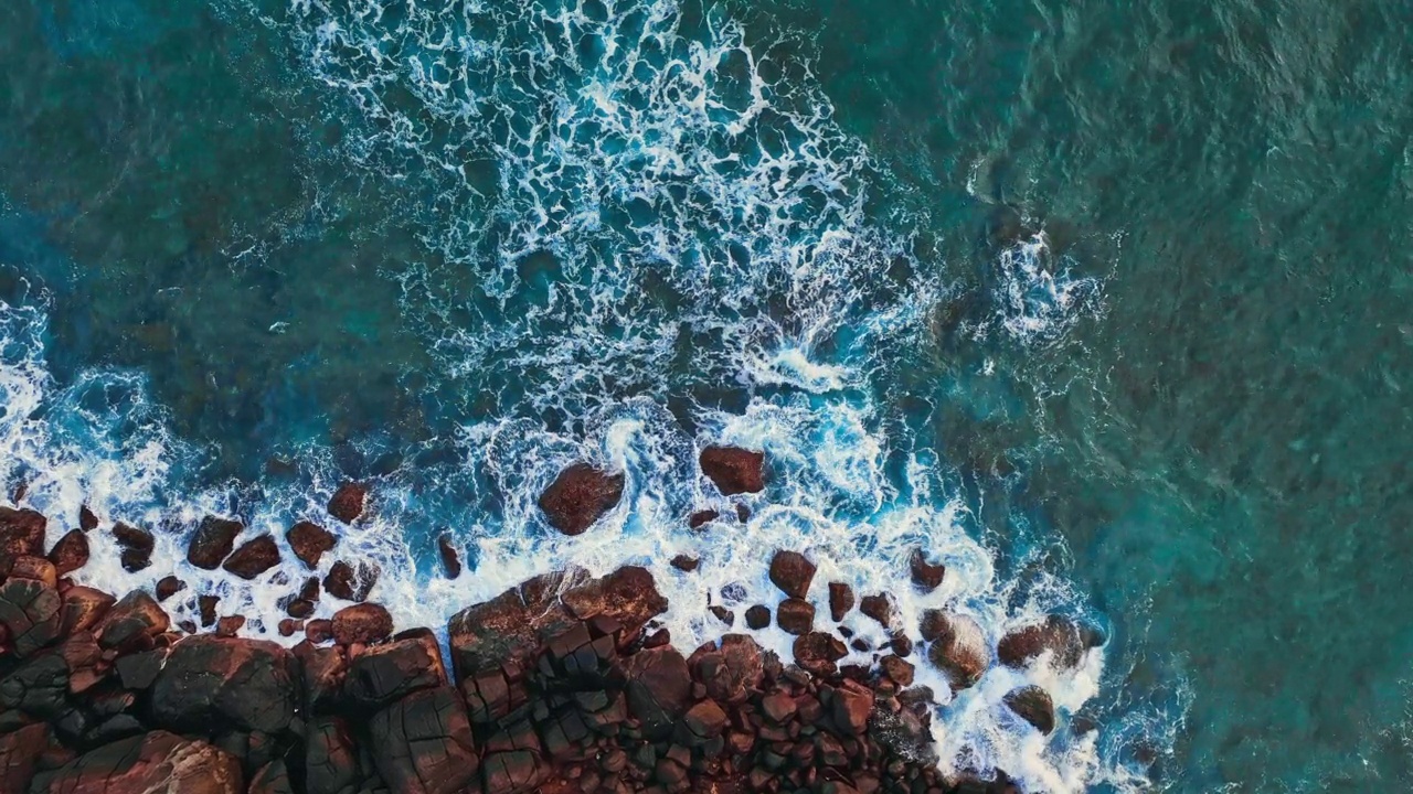 慢动作的海浪冲击着布满岩石的海岸线视频素材