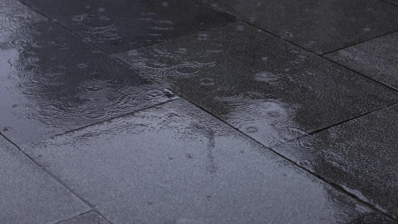 下雨天，城市街道上的水坑缓缓移动视频素材