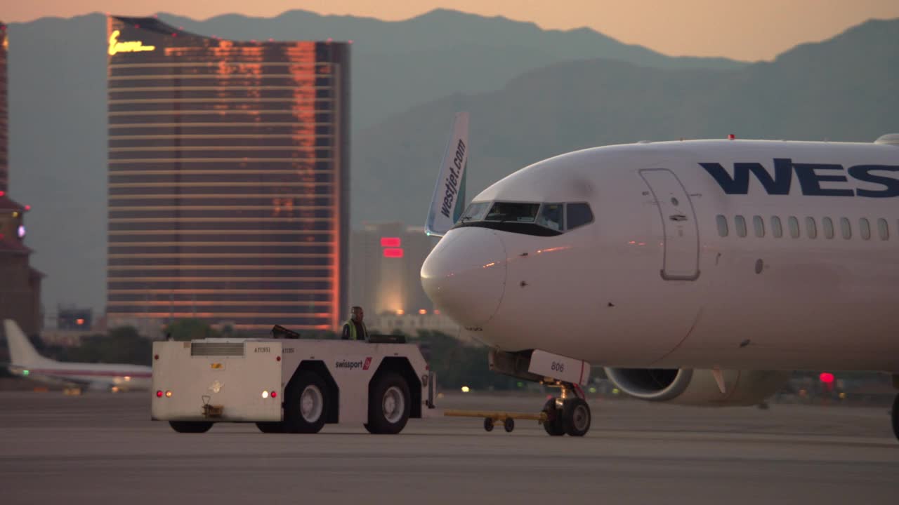 西捷航空波音737飞机在内华达州LAS / LAS Vegas被一架飞机拖船拖着视频素材