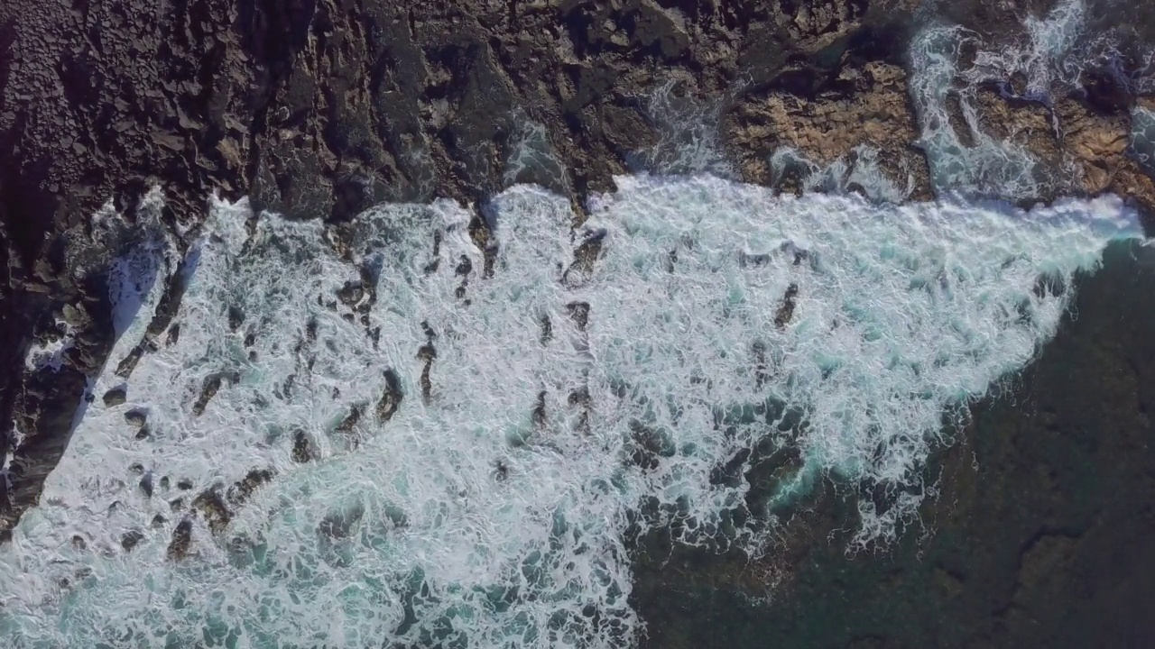 顶部鸟瞰海浪拍打岩石背景，兰萨罗特，加那利群岛，西班牙。视频素材