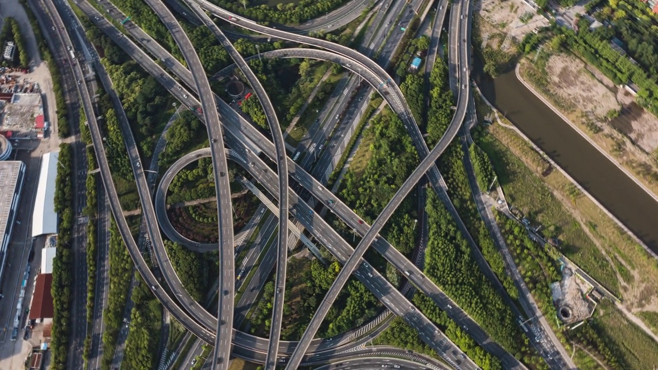 延时，鸟瞰图的道路立交或公路交叉口与繁忙的城市交通在道路上超速。无人机运输枢纽网络。视频素材