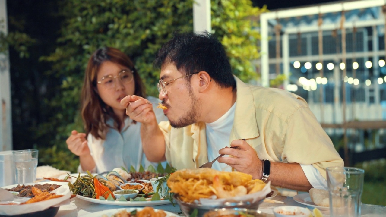 一对夫妇在亚洲餐厅享用木瓜沙拉和晚餐。视频素材