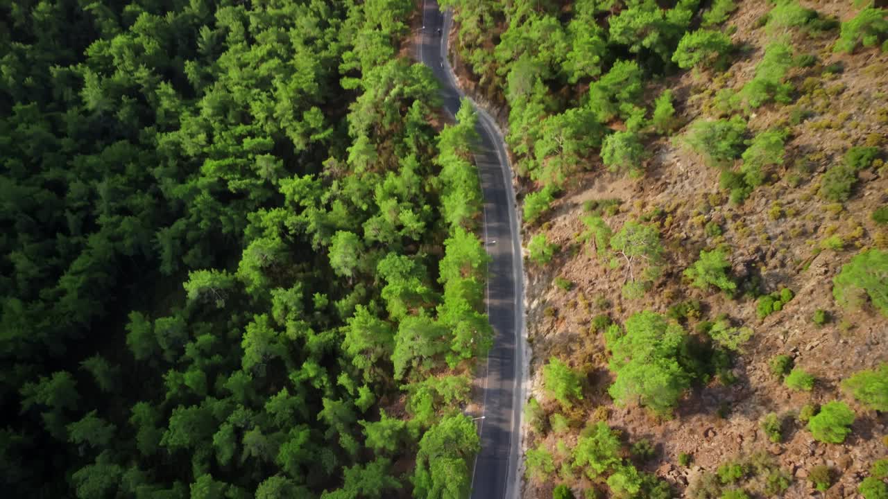 空中拍摄的山间公路和在温暖的夏日乘坐汽车的画面视频素材