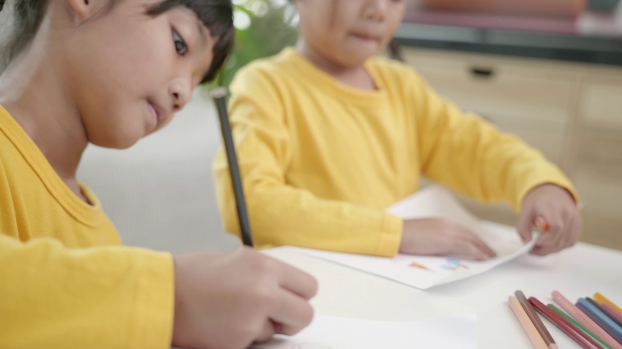 亚洲女孩在家画画的场景。孩子们像童年一样在一起玩耍，节日概念视频素材