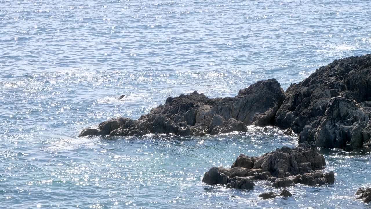 海浪拍打着岩石。大西洋的水域。手持视频。盯着水面。阳光明媚的天气。视频素材