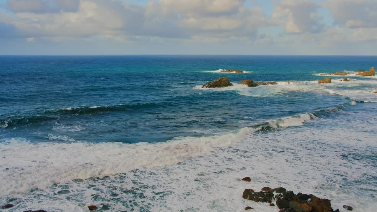 五彩缤纷的海滩，浪花在多石的海岸线上翻腾飞溅。阿纳加自然公园，特内里费北部开阔海域的海浪。视频素材