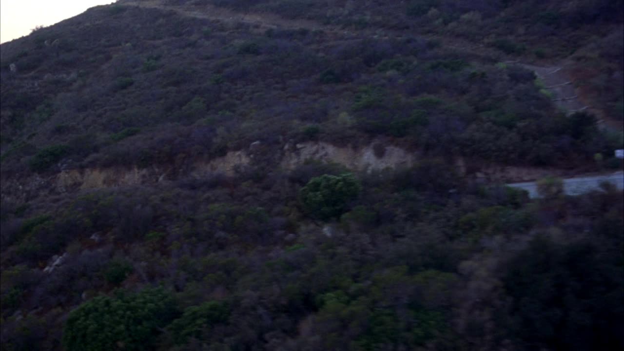 沿山路空运。波夫跟着一辆黑色豪华轿车。在bg中看到海洋和海岸视频素材