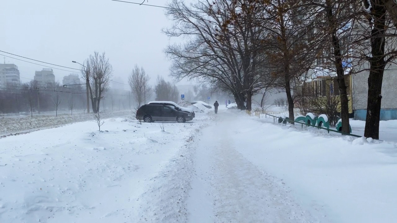 雪在城市的道路上与汽车一月视频素材