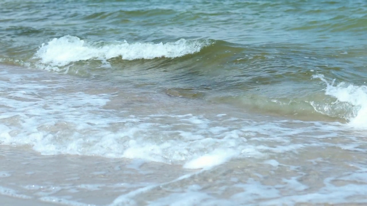 海边的海浪扑在沙滩上，海边的海浪扑在沙滩上视频素材