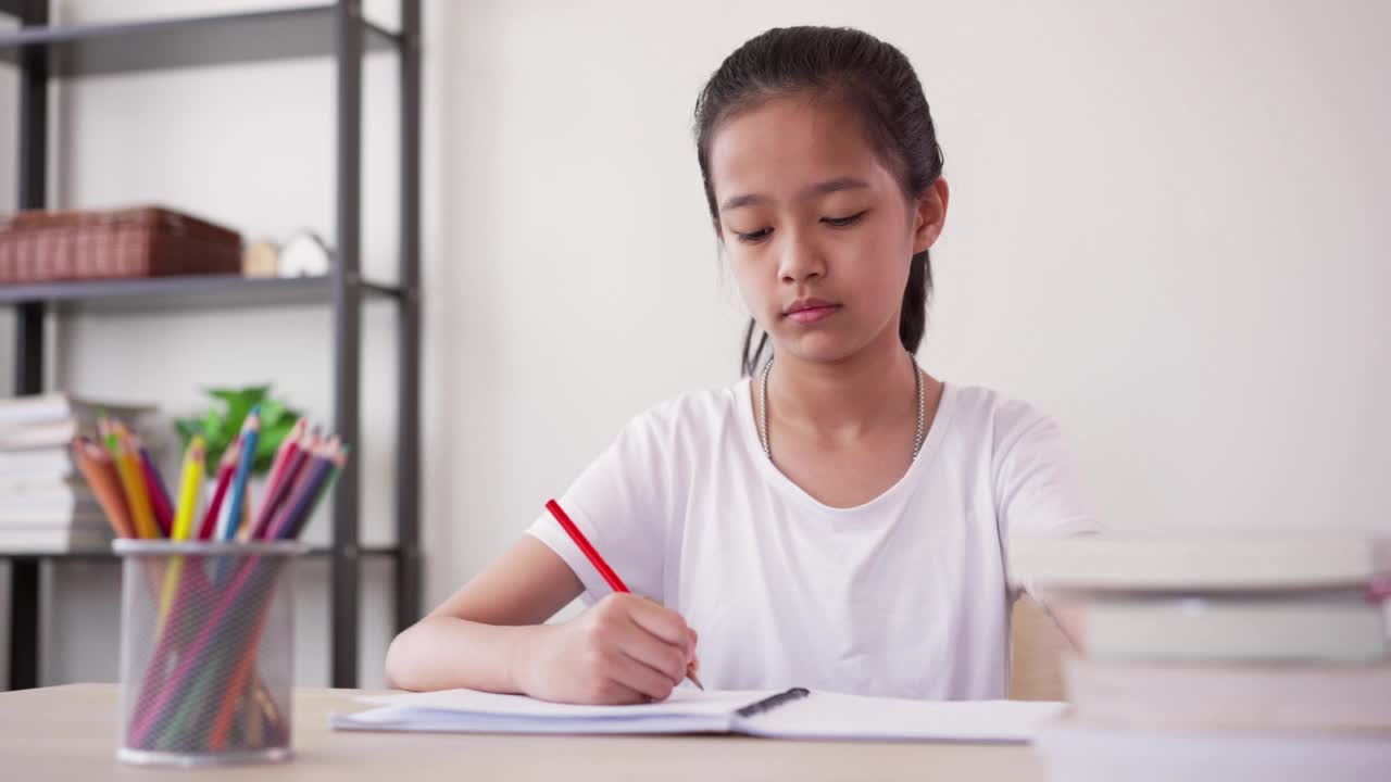 压力集中的女孩在家里学习和做作业感到头痛视频素材