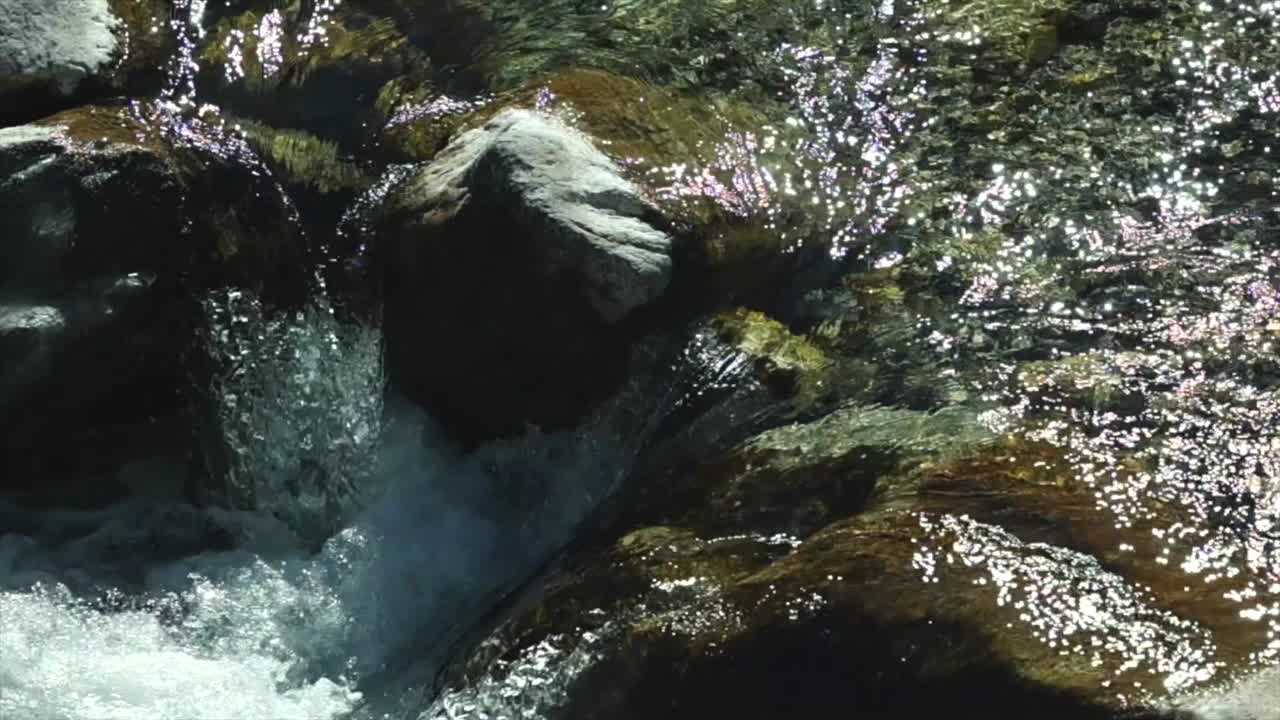 水从岩石上流下，被阳光照亮视频素材