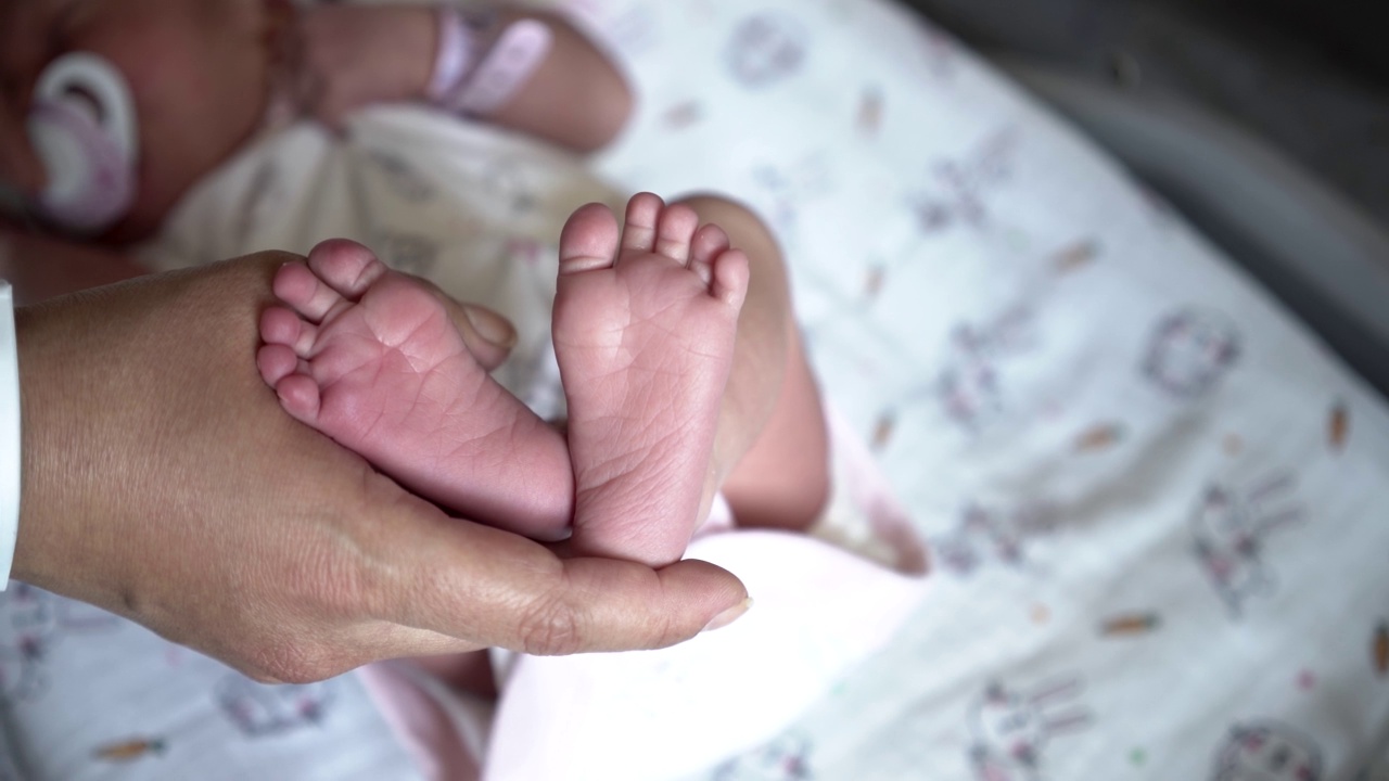 母亲抱着新生婴儿的脚视频素材