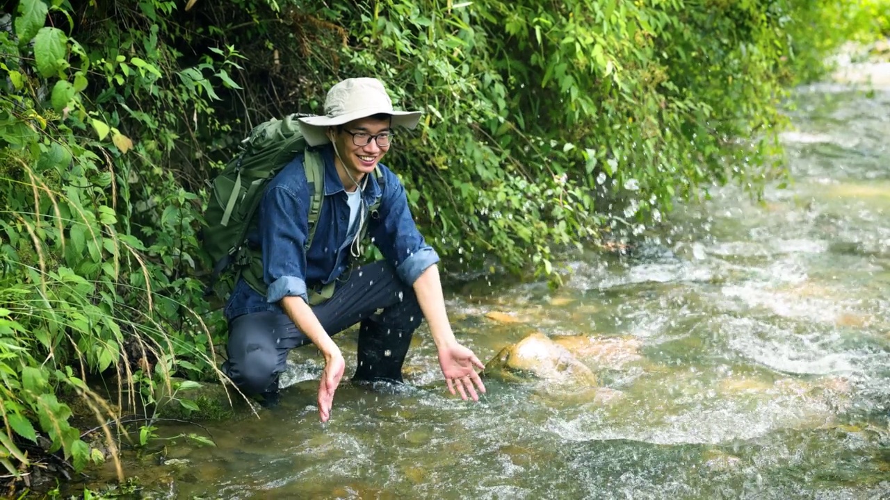 徒步旅行者在山涧中玩水视频素材