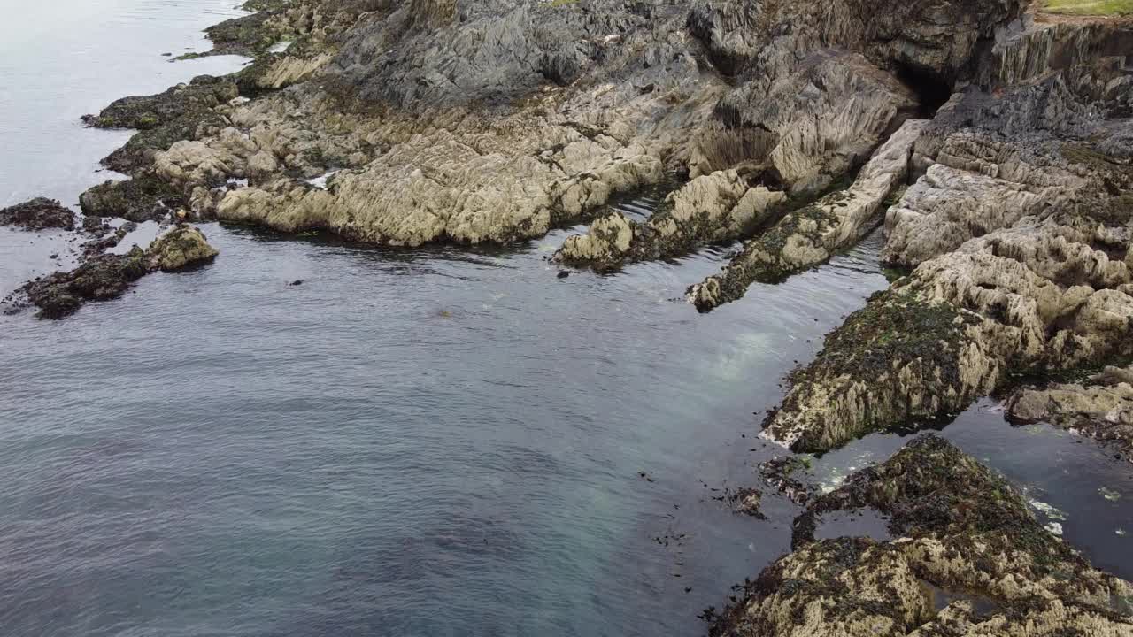 岩石海岸，俯视。水面平静，水面泛起小涟漪。海岸的岩石。视频素材