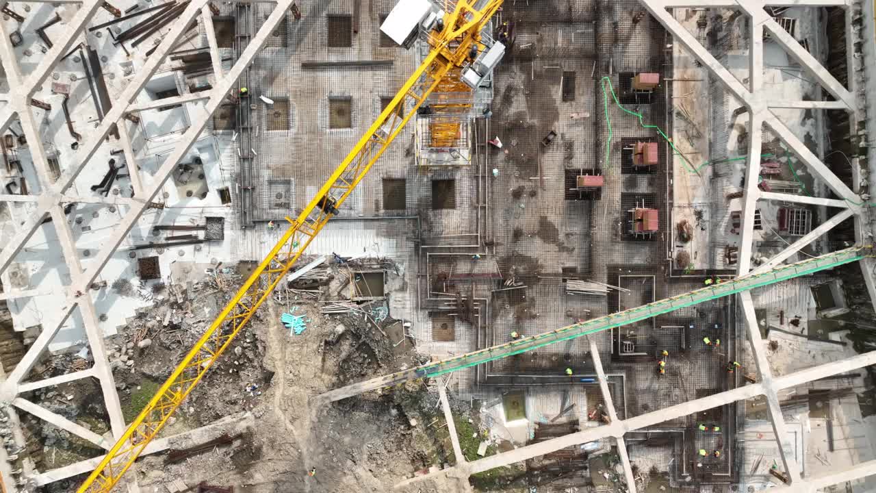 建筑工地、起重机和工人。无人机的鸟瞰图视频素材