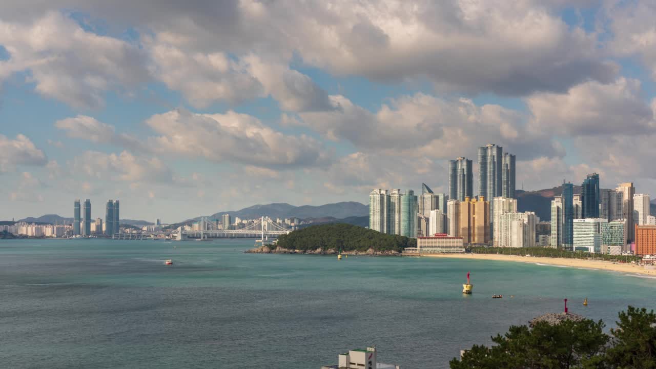 韩国釜山海云台区附近的海云台海水浴场、东白石岛、光大路大桥等白天的市中心风景视频素材